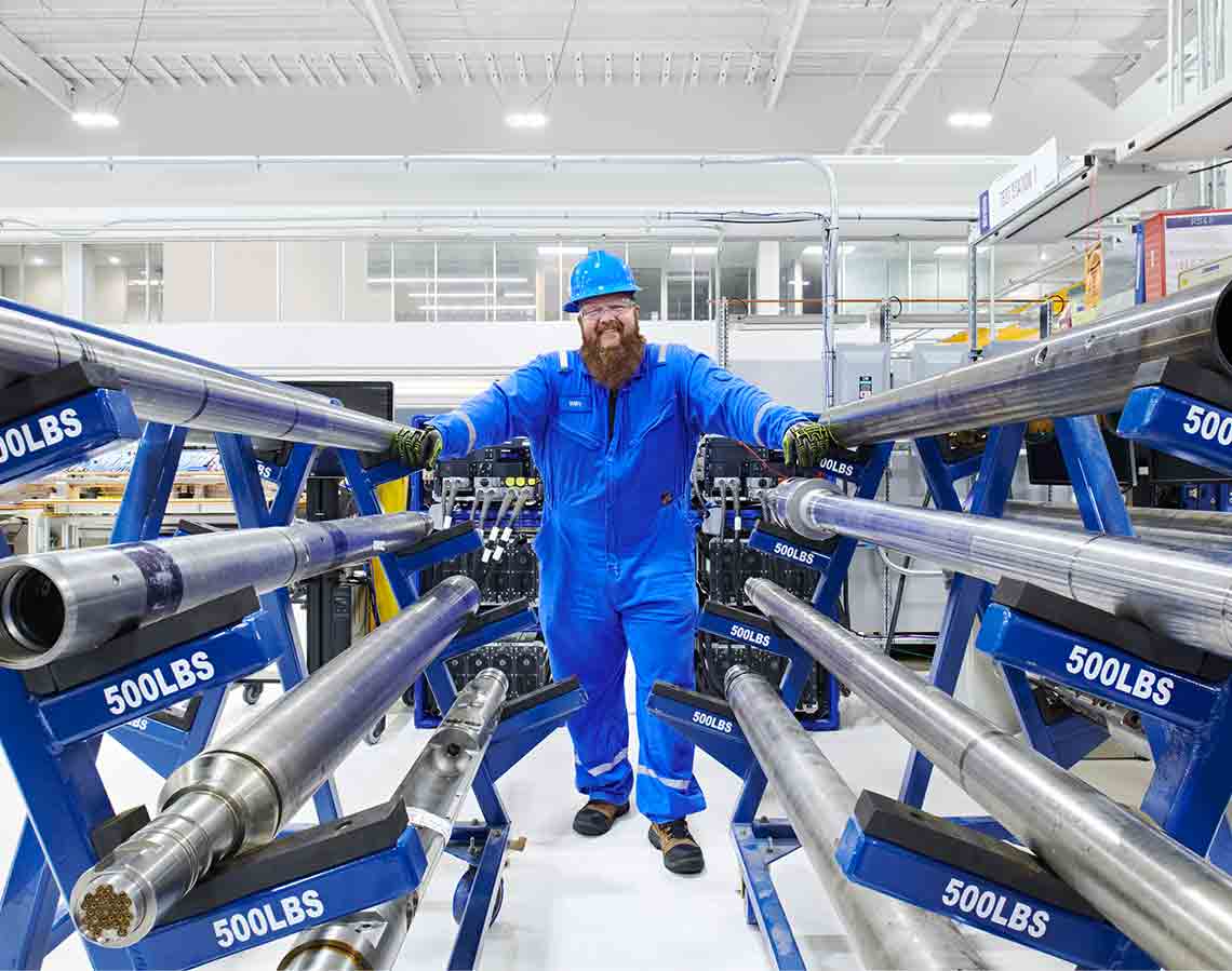 Man standing with equipment at manufacturing facility (Tier 1_ManufacturingFacility_Sugar Land_AML_5413)