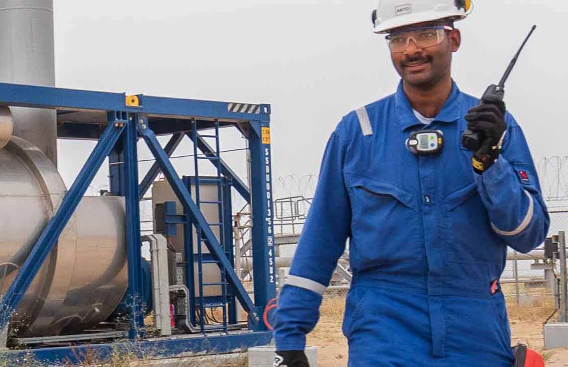Schlumberger field worker monitoring an early production facility.